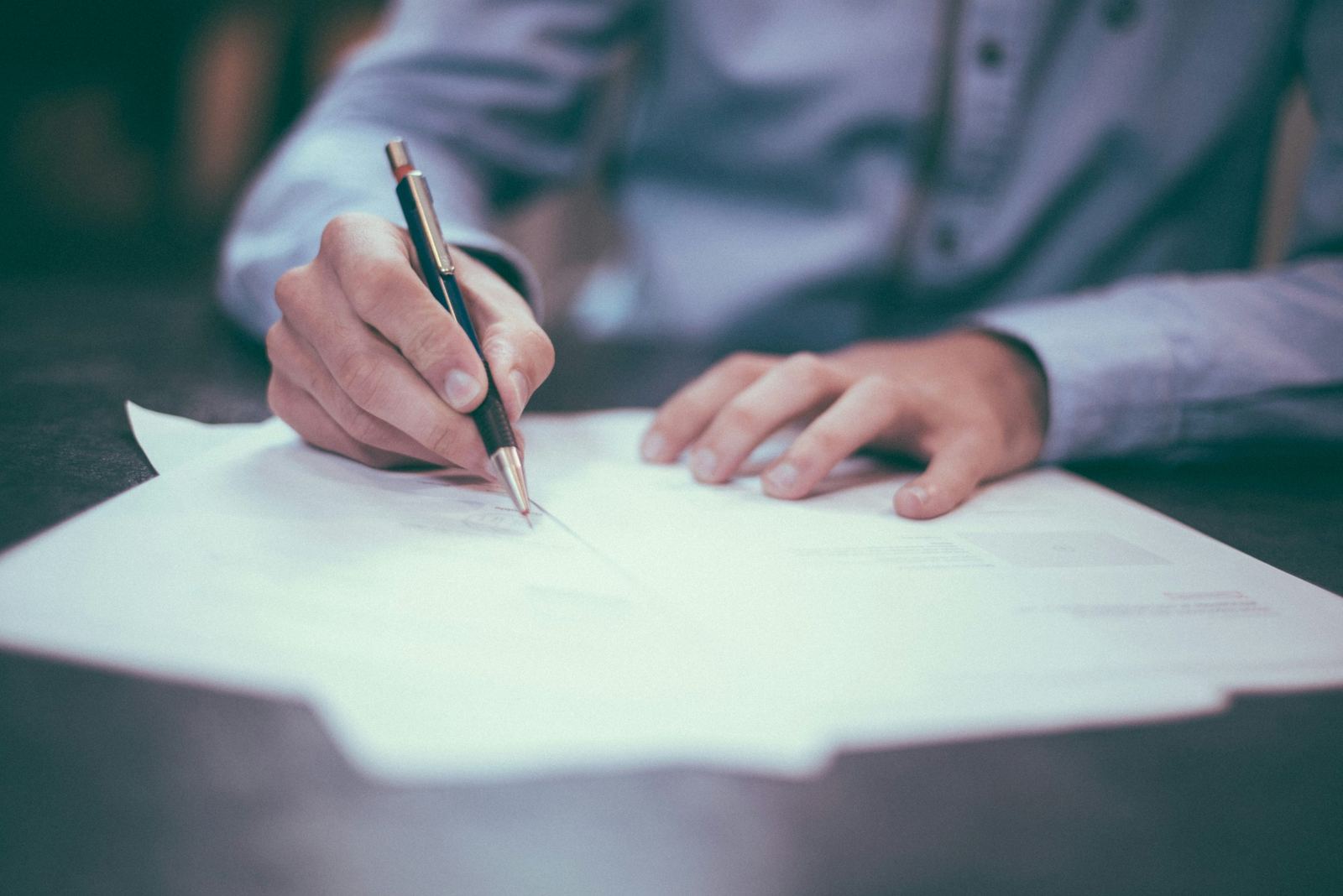 An image of a man writing a legal document - Stress as a lawyer