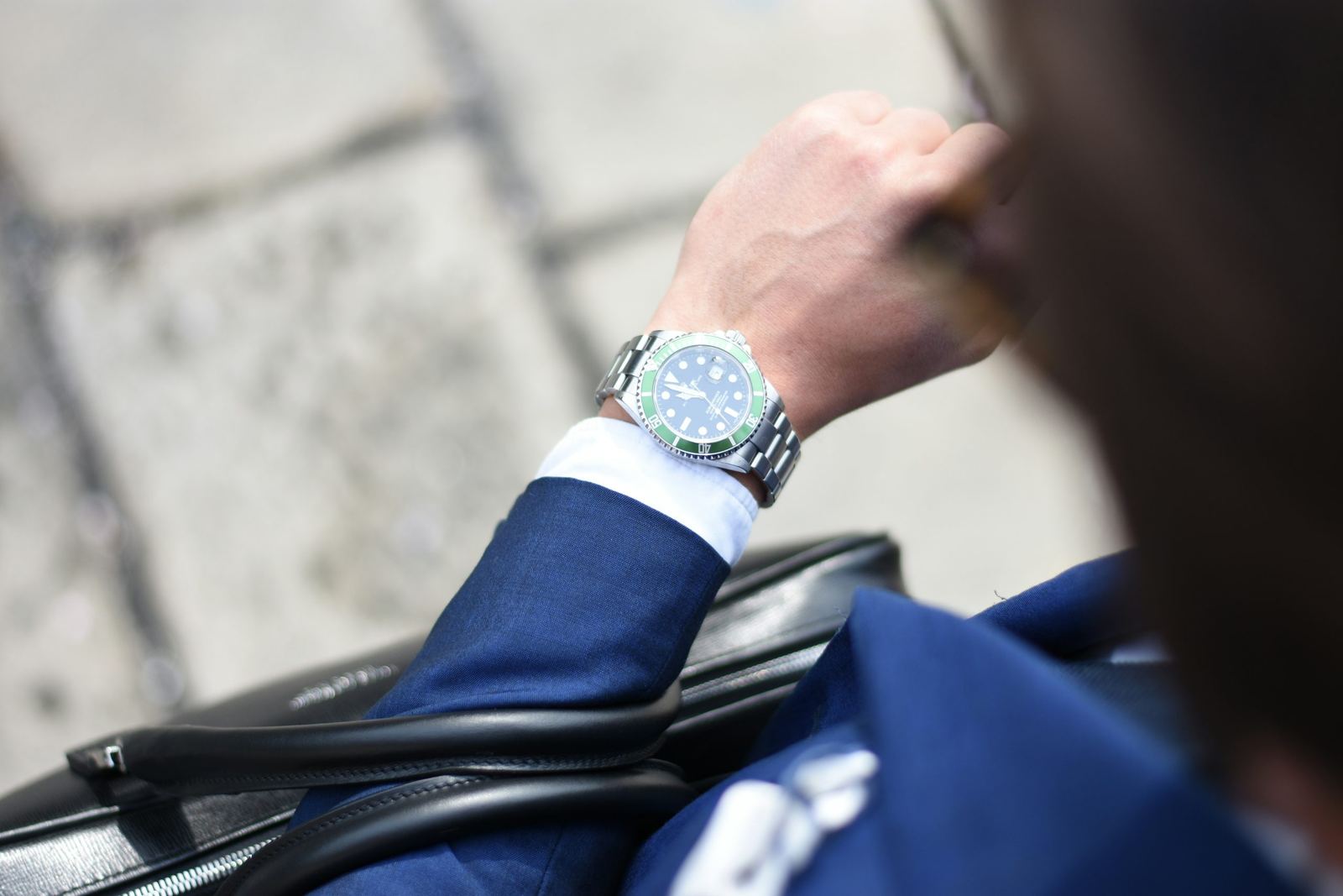 An image of a man looking at a watch on his wrist