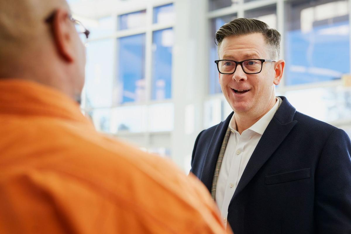 An image of a man chatting to another man