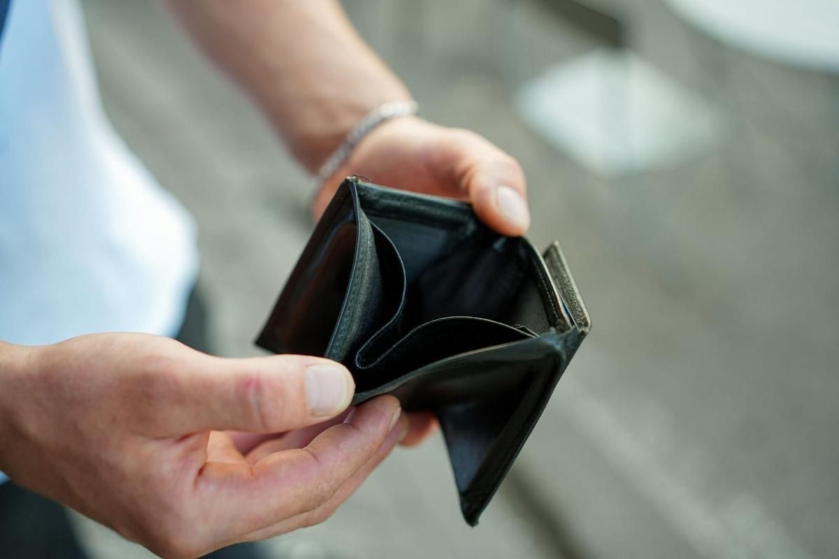 hands holing open an empty black wallet