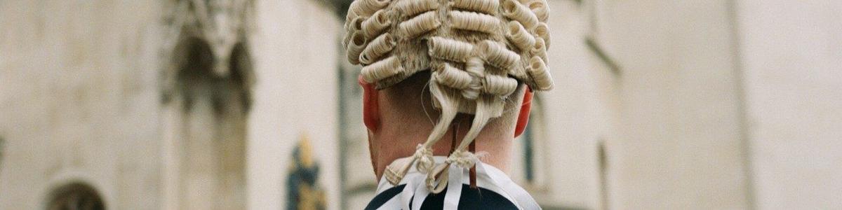 An image of a barrister in wig on way to court
