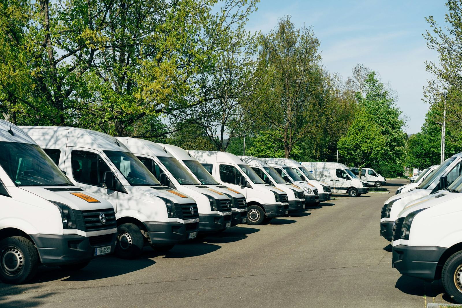 Commercial van fleet parked at a transport depot