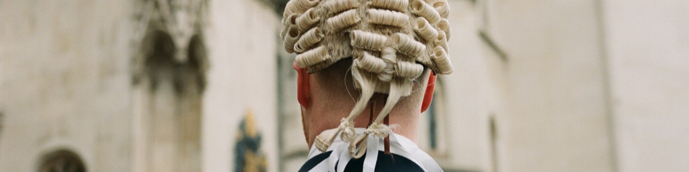An image of a barrister in wig on way to court