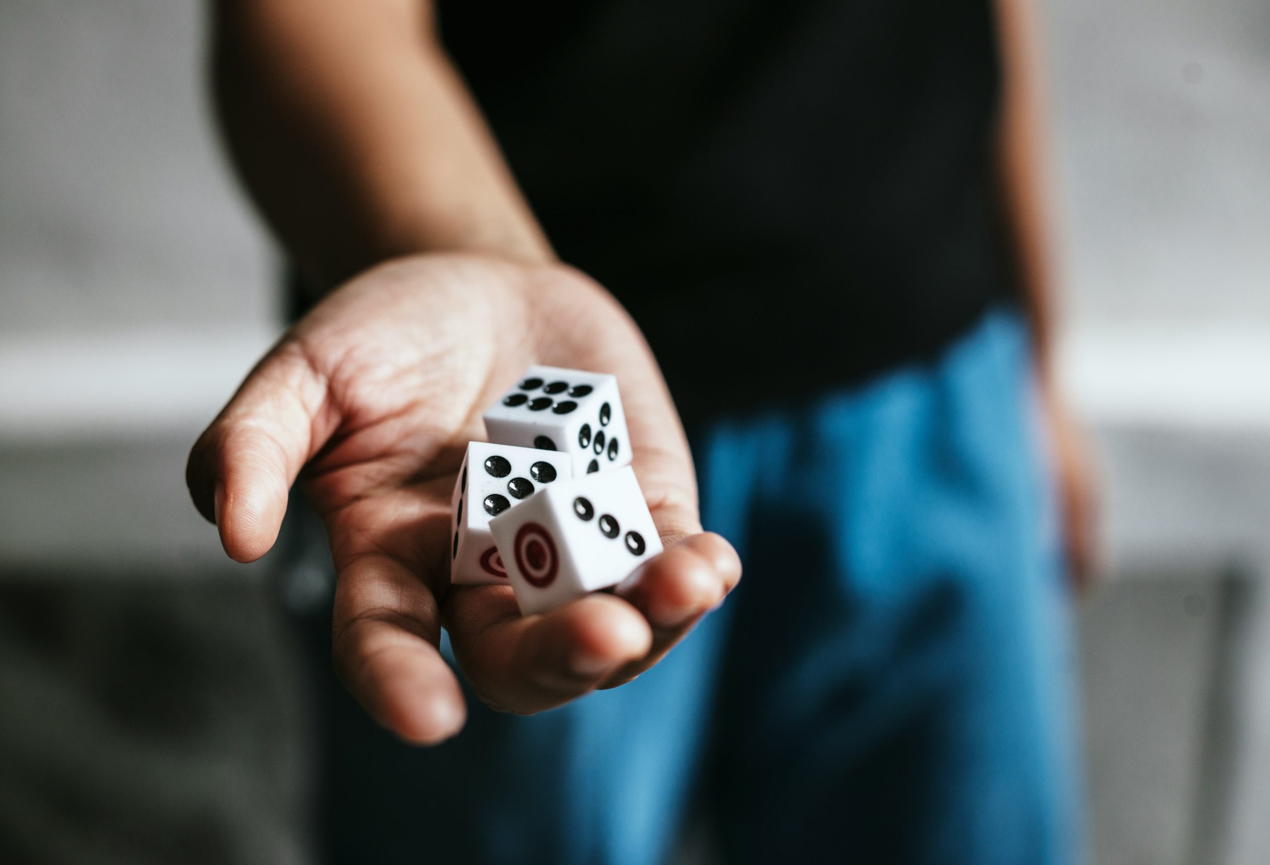 An image of a had holding three dice to symbolise risk